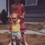 Big sister Kathleen helps Jessica learn how to walk outside. (10/1978)