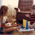 Cousins Jessica and Christopher play Connect Four on the floor at Grandma and Grandpa's house in Valparaiso, Indiana. (6/1982)