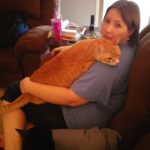 Jessica cradles her cat Cheetoe. (11/20/2005)