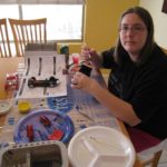 Jessica putting together a model car kit in her kitchen. (11/7/2009)