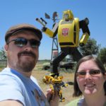 Andrew and Jessica pose in front of a large Bumblebee statue in California. (7/3/2010)