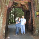 Jessica and Andrew pose inside a drive through tree near the Redwoods. (7/8/2010)