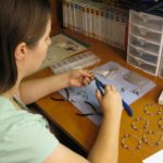 Jessica hand crafting bracelets and jewelry. (5/28/2011)