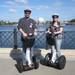 Andrew and Jessica pose on top of Segways they were able to ride around Epcot, Walt Disney World. (2/1/2012)