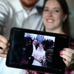 Andrew and Jessica hold up a photo of their wedding, while posing for 10-year anniversary portraits. (2/2/2012)