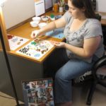 Jessica putting together a LEGO set in her office that she received for Christmas. (12/25/2012)